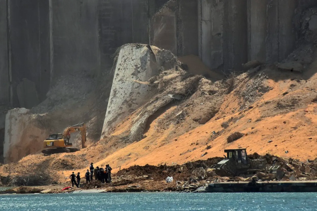 Rescuers gather near the heavily damaged grain silo in the Port of Beirut, four days after a monster explosion killed hundreds of people and disfigured the Lebanese capital, on August 8, 2020. Photo: AFP
